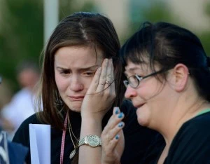 Dara Anderson (L) and Monique Anderson cry during a candelight vigil Dara Anderson (L) and Monique Anderson cry during a candelight vigil