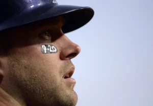 Andrew Brown of the Colorado Rockies wears a "7-20" eye sticker in memory of the shooting victims. Andrew Brown of the Colorado Rockies wears a "7-20" eye sticker in memory of the shooting victims.