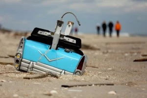 A dislodged amusement park bumper car is partially submerged in the sand in Bay Head A dislodged amusement park bumper car is partially submerged in the sand in Bay Head
