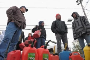 People line up to fill gas canisters at a Shell gas station People line up to fill gas canisters at a Shell gas station