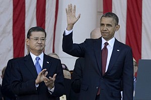 President Barack Obama (R) waves to guests beside US Secretary of Veterans Affairs Eric Shinseki (L) on Veteran's Day at the Tomb of the Unknown Soldier in Arlington National Cemetery President Barack Obama (R) waves to guests beside US Secretary of Veterans Affairs Eric Shinseki (L) on Veteran's Day at the Tomb of the Unknown Soldier in Arlington National Cemetery