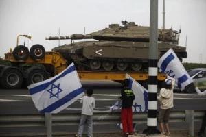 Israeli children wave their national flag as they greet a convoy of tanks passing on a road leading to the Israel-Gaza border near the southern Israeli town of Ofakim Israeli children wave their national flag as they greet a convoy of tanks passing on a road leading to the Israel-Gaza border near the southern Israeli town of Ofakim