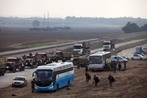 Israeli reserve soldiers and army vehicles depart the Gaza border area Israeli reserve soldiers and army vehicles depart the Gaza border area