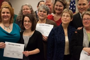 Several of the first couples to receive same-sex marriage licenses in Washington state pose with King County Executive Dow Constantine (Top,R), who signed their licenses Several of the first couples to receive same-sex marriage licenses in Washington state pose with King County Executive Dow Constantine (Top,R), who signed their licenses