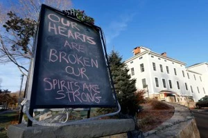 A sign outside of a business in downtown Newtown reads, 'Our hearts are broken, our spirits are strong', A sign outside of a business in downtown Newtown reads, 'Our hearts are broken, our spirits are strong',