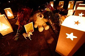 : Candles surround gifts and flowers that were left in honor of the victims of the mass shooting at Sandy Hook elementary school : Candles surround gifts and flowers that were left in honor of the victims of the mass shooting at Sandy Hook elementary school