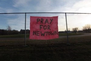 A handwritten sign reads 'Pray for Newtown' A handwritten sign reads 'Pray for Newtown'