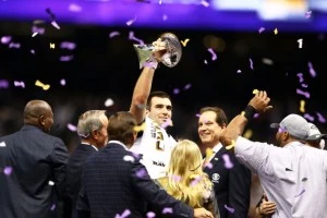 Joe Flacco #5 of the Baltimore Ravens holds up the Vince Lombardi Trophy next to CBS host Jim Nantz Joe Flacco #5 of the Baltimore Ravens holds up the Vince Lombardi Trophy next to CBS host Jim Nantz