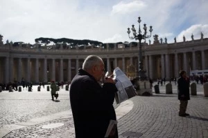 A man reads a paper in St Peter's Square the morning after the election of Pope Cardinal Jorge Mario Bergoglio of Argentina A man reads a paper in St Peter's Square the morning after the election of Pope Cardinal Jorge Mario Bergoglio of Argentina