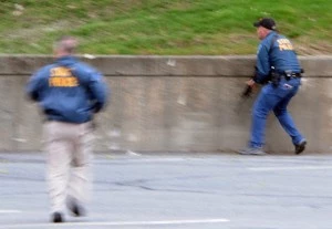 Law enforcement approach an area where a suspect is hiding on Franklin St. in Watertown, Mass Law enforcement approach an area where a suspect is hiding on Franklin St. in Watertown, Mass