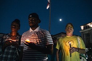 Brittany Carter, of Bowie, MD., (L) Jibri Johnson, of Landon, MD., (C) and Bryan Beard of Washington D.C. hold candles at a vigil for Navy Yard shooting victims Brittany Carter, of Bowie, MD., (L) Jibri Johnson, of Landon, MD., (C) and Bryan Beard of Washington D.C. hold candles at a vigil for Navy Yard shooting victims