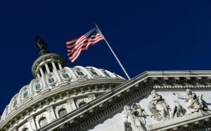 An American flag waves outside the United States Capitol building An American flag waves outside the United States Capitol building