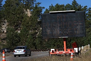 A sign along the highway near the entrance to Mount Rushmore National Memorial warns visitors that the park is closed A sign along the highway near the entrance to Mount Rushmore National Memorial warns visitors that the park is closed