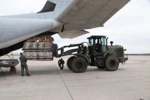 Palletized equipment is loaded onto a KC-130J Hercules aircraft at Marine Corps Air Station Futenma during preparation for a humanitarian assistance and disaster relief mission to the Philippines Palletized equipment is loaded onto a KC-130J Hercules aircraft at Marine Corps Air Station Futenma during preparation for a humanitarian assistance and disaster relief mission to the Philippines