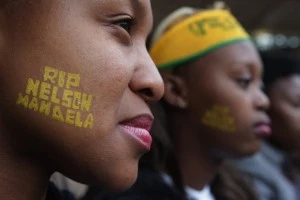 Two young women attend the official memorial service for former South African President Nelson Mandela at FNB Stadium In Johannesburg Two young women attend the official memorial service for former South African President Nelson Mandela at FNB Stadium In Johannesburg