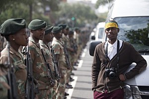 A man waits following the passing of the funeral cortege of former South African president Nelson Mandela along Madiba St in Pretoria, South Africa. A man waits following the passing of the funeral cortege of former South African president Nelson Mandela along Madiba St in Pretoria, South Africa.