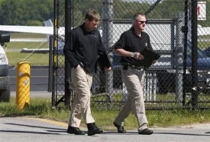 A federal investigator, left, and a state investigator leave the secure area at Hanscom Field in Bedford, Mass A federal investigator, left, and a state investigator leave the secure area at Hanscom Field in Bedford, Mass