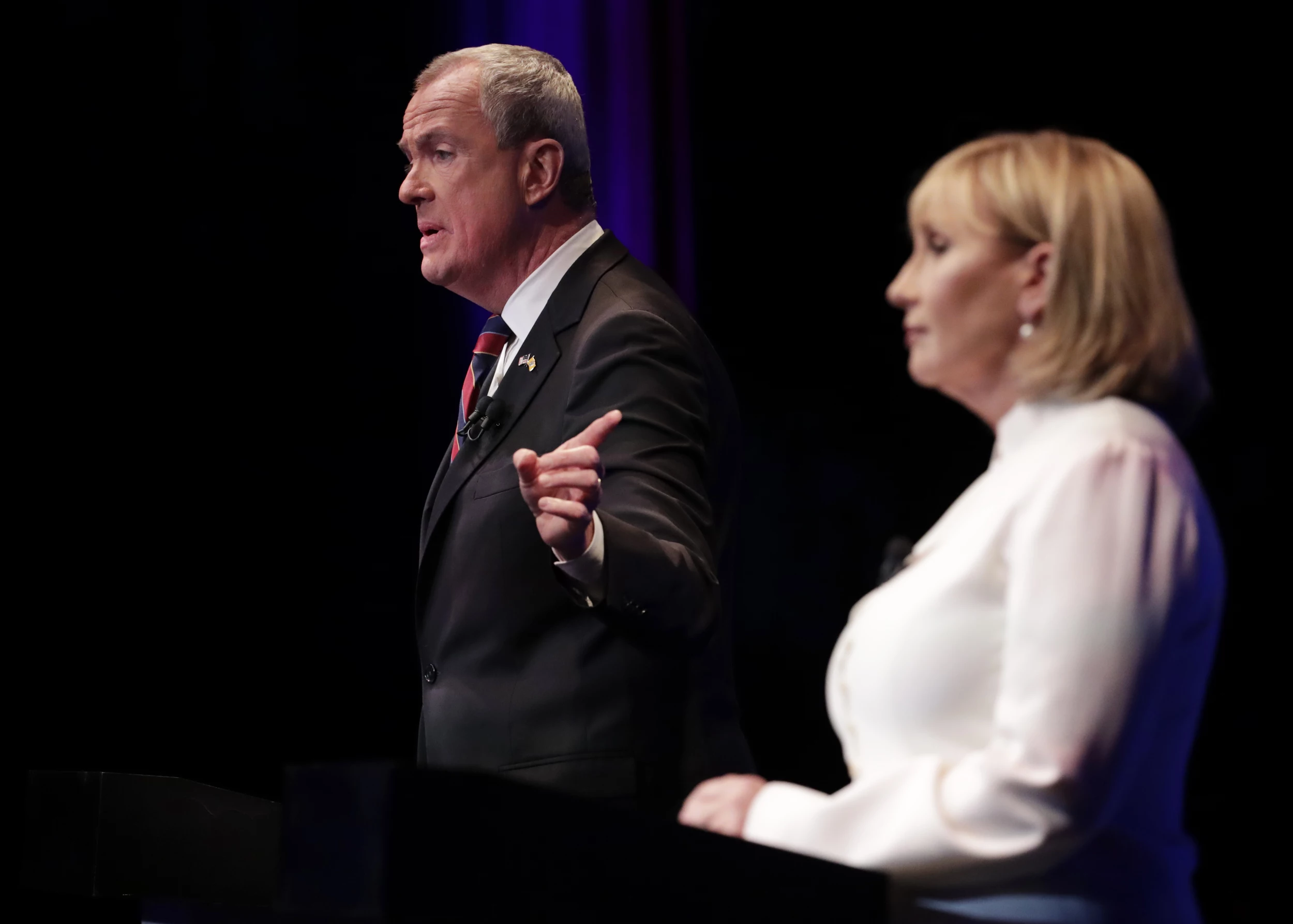 Democratic nominee Phil Murphy, left, answers a question as Republican nominee Lt. Gov. Kim Guadagno, right, during Tuesday night's gubernatrial debate at NJ PAC in Newark