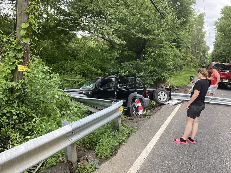 Onlookers take photos after an accident in Roosevelt, NJ, where an SUV was impaled by a guardrail. Photo: Richard A Bell via Facebook