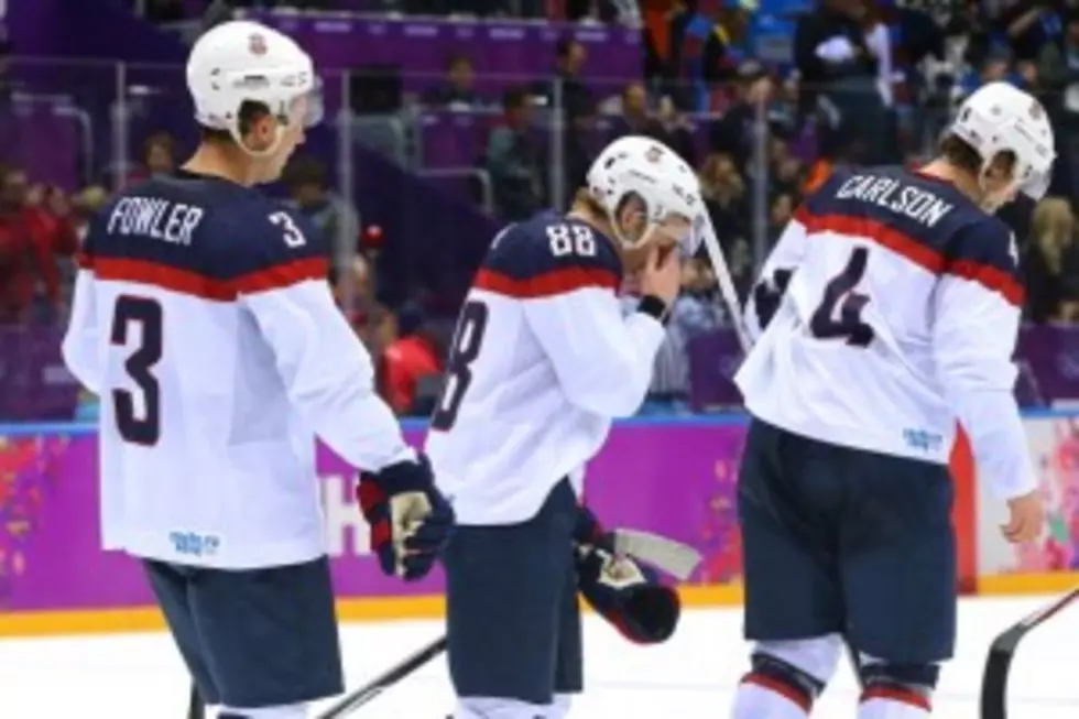 Cam Fowler #3, Patrick Kane #88 and John Carlson #4 of the United States react after losing 1-0 to Canada