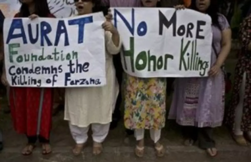 Members of Pakistan's civil society, hold banners and chant slogans, during a protest to condemn the killing of pregnant woman Farzana Parveen, who was stoned to death, in Islamabad, Pakistan, Thursday, May 29, 2014. (AP Photo/Muhammed Muheisen)