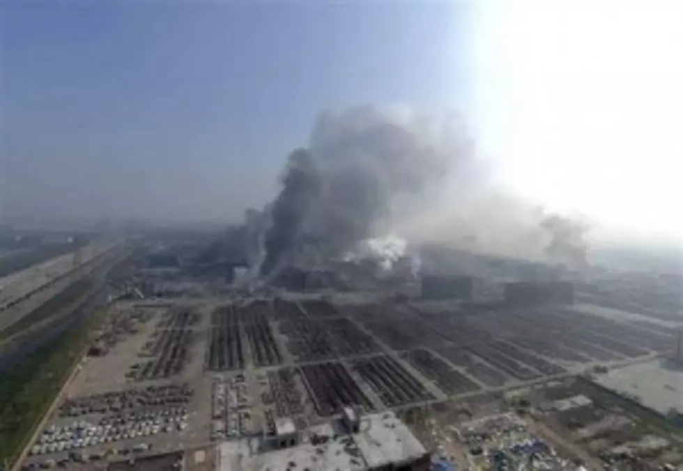 Smoke rises from the site of explosions from a nearby building in the Binhai New Area in northeastern China's Tianjin municipality